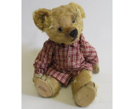 A pre-war Chad Valley growling teddy, with clear plastic eyes, celluloid maker's button to ear, sewn nose and mouth, squeeze 
