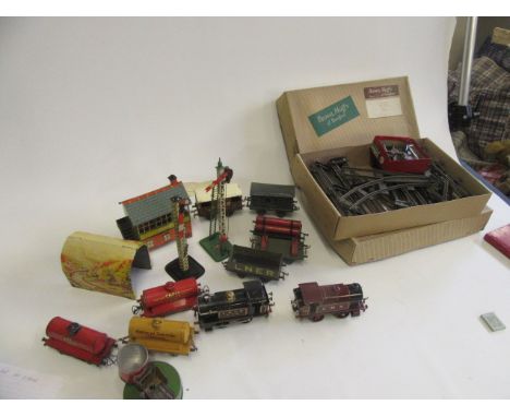 Playworn Hornby trains with clockwork 0-4-0 L.M.S. tank, clockwork L.N.E.R. tank, seven goods trucks, signal box, signals, tu