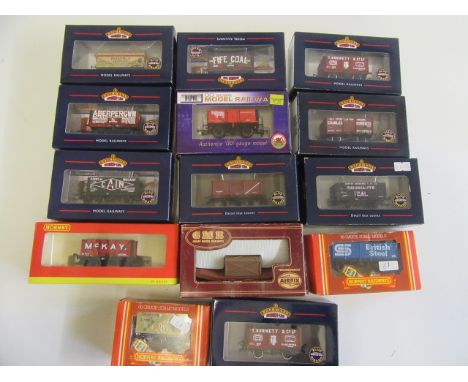 Fourteen goods wagons by Bachmann, Hornby and Dapol including P.O. coal truck and tank wagon, all items boxed, E (Est. plus 2