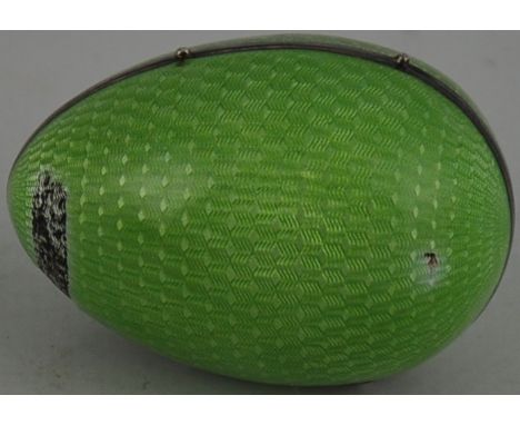 An early 20th Century French silver and pale green guilocche enamel egg shaped box