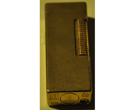 A gold plated Dunhill Rollergas cigarette lighter with engine turned body