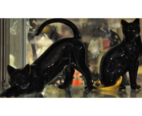 A ceramic cat mid-stretch, together with another (2)