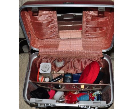 A vintage vanity case with various toiletries and perfumes 