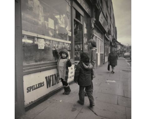 A black & white photographic print on canvas, children at a pet shop window, 1970s. Dim: 79 x 76cm