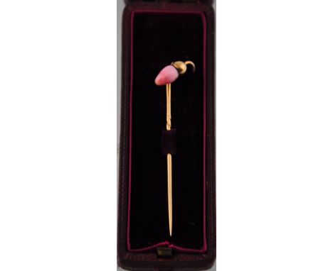 A yellow metal stick pin, with conch pearl, modelled as an acorn