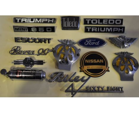A collection of vintage chrome and composite car badges including two 'AA' and a Kwik chrome Airex motor fine extinguisher 