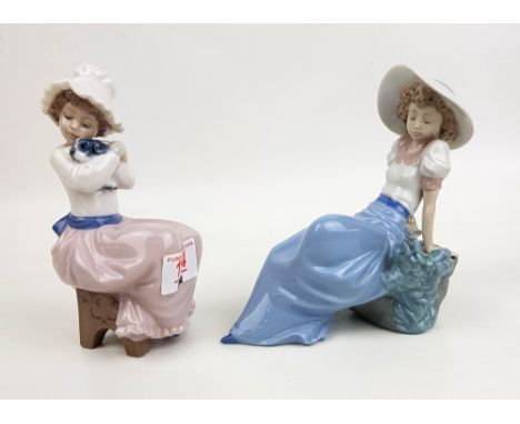 Two Nao figurines: seated girl with puppy &amp; reclining girl with garden bird (2). 