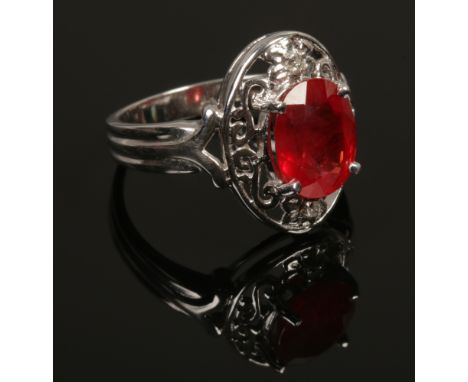 An 18ct white gold padparadscha sapphire and diamond ring with certificate, size N. (5.81g).