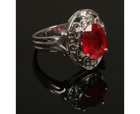 An 18ct white gold padparadscha sapphire and diamond ring with certificate, size N. (5.81g).