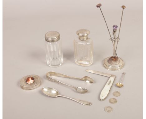 A group of silver to include portrait trinket box, sugar tongs, silver and mother of pearl handled pocket knife, silver toppe