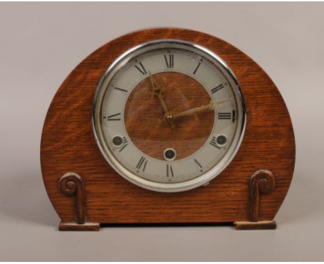 A carved oak Anvil dome top mantle clock striking on four gongs, movement stamped perivale.