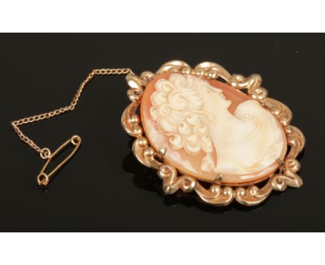 A 9ct gold shell cameo brooch portrait of a maiden, makers mark for WJP with safety chain.