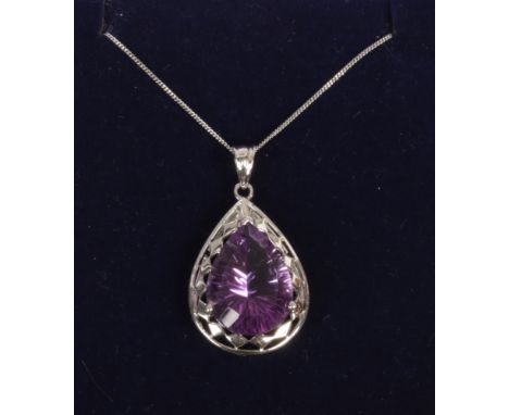 A 9ct white gold pendant on chain set with a large pear cut amethyst.