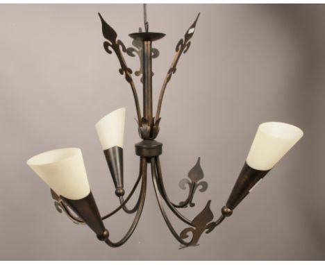A decorative three branch ceiling light fitting formed in wrought iron work with milchglas shades.