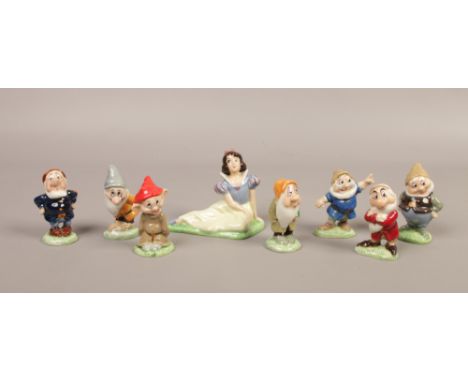 An assembled set of Wade ceramic Disney's Snow White and the Seven Dwarfs figures.