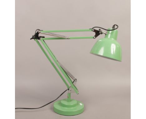 A painted anglepoise lamp with weighted circular stepped base.
