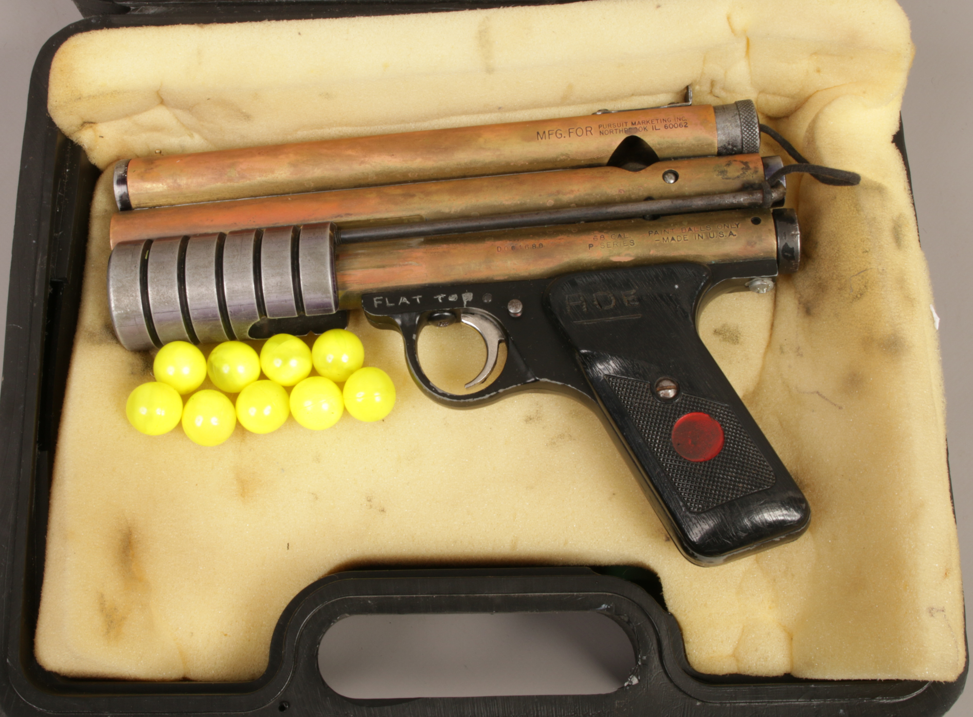 A cased MFG 68 cal P series air powered paintball pistol.