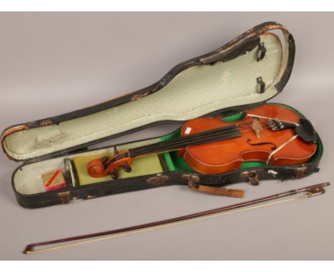 A cased sweet tone violin and bow made in Shanghai China.