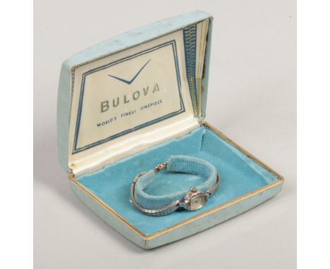 A ladies Bulova white rolled gold manual cocktail watch. With applied numeral and dot markers and in original box, 13mm wide.