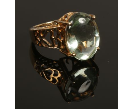 A 9ct gold dress ring set with a large ovoid pale green amethyst stone, size N 1/2.