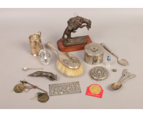 A box of metalware collectables including Franklin Mint Broncho Buster, silver backed brush and a Yorkshire penny bank etc.