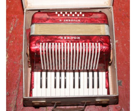A cased Hohner student II accordion.