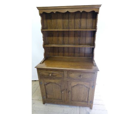 Small oak dresser, three shelf back with shaped frieze, base with two drawers above two doors with acorn handles, W92cm D43cm