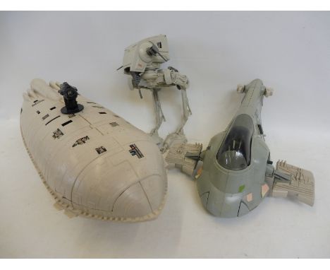 A group of original Star Wars models comprising a Darth Vader slave ship, a rebel transporter and a scout walker, largely com