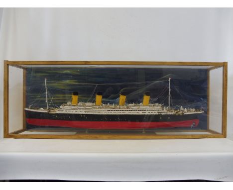 A cased scale model of the Titanic, made from 100 issues detailing the build, plus related history etc.