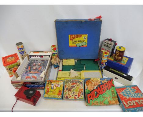 A collection of games including Bayko Converting sets, a Tomy Atomic Arcade Pinball game, Fisher Price etc.