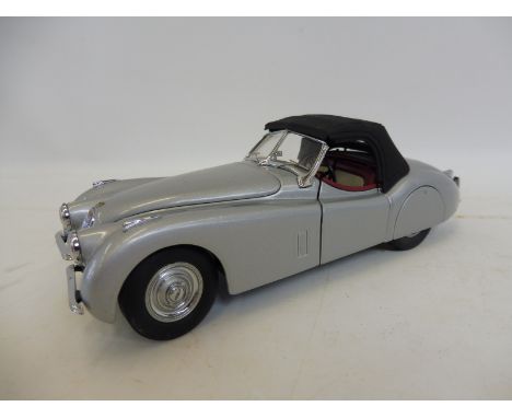 A Franklin Mint scale model of a 1952 Jaguar XK120.