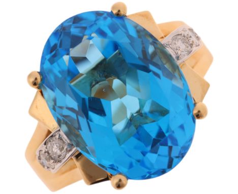 An 18ct gold blue topaz diamond cocktail ring, claw set with oval mixed-cut topaz and modern round brilliant-cut diamond shou