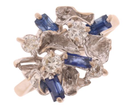 An 18ct white gold sapphire and diamond abstract cocktail ring, set with baguette-cut sapphires and modern round brilliant-cu