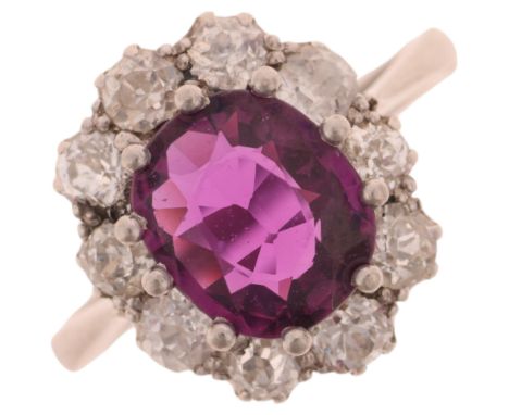 A platinum synthetic ruby and diamond flowerhead cluster ring, claw set with oval mixed-cut synthetic ruby surrounded by old 