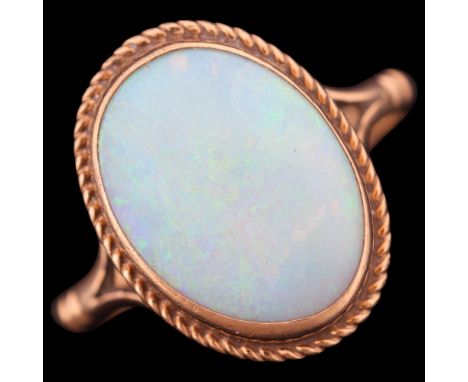 A 9ct gold single stone opal dress ring, set with oval cabochon opal within rope twist surround, setting height 16mm, size N,