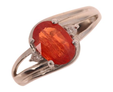 An 18ct white gold spessartine orange garnet and diamond dress ring, maker GTV, Birmingham 2005, claw set with oval mixed-cut