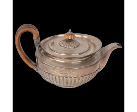 A George III silver teapot, William Burwash, London 1813, circular squat form with relief embossed half fluted decoration, do