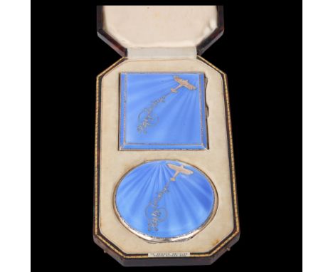 An Art Deco George V silver and blue enamel 'Happy Landings' matching cigarette case and powder compact set, Adie Brothers Lt