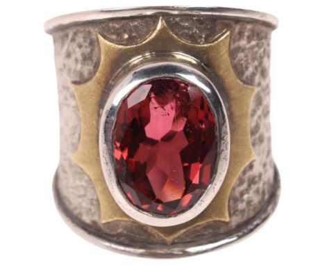 KIM POOR - a sterling silver and 18ct gold pink tourmaline band ring, rub-over set with oval mixed-cut pink tourmaline, withi