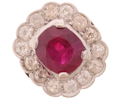 A French platinum ruby and diamond cluster cocktail ring, set with 4ct oval mixed-cut ruby surrounded by row of old-cut diamo
