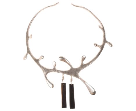 A handmade sterling silver abstract neck torque, maker A&C, organic form with textured decoration and ebonised wood drops, in