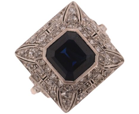 A platinum sapphire and diamond cluster cocktail ring, rub-over set with octagonal step-cut sapphire surrounded by old-cut di