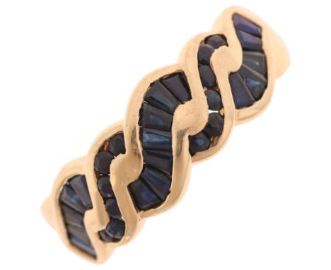 A 9ct gold sapphire wavy band ring, channel set with round and tapered baguette-cut sapphires, setting height 7.9mm, size R, 