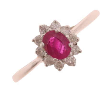 An 18ct white gold ruby and diamond oval cluster ring, set with oval mixed-cut ruby and modern round brilliant-cut diamonds, 