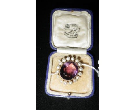 AN AMETHYST AND SEED PEARL MOUNTED BROOCH
