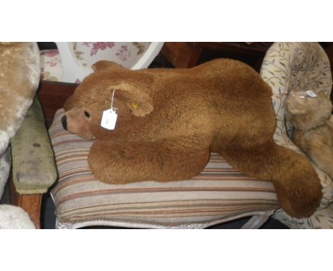 A LARGE STEIFF BEAR, c. 32" long with yellow label and button in ear (eats very little)