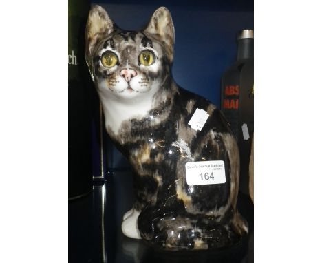 A WINSTANLEY CERAMIC CAT with glass eyes