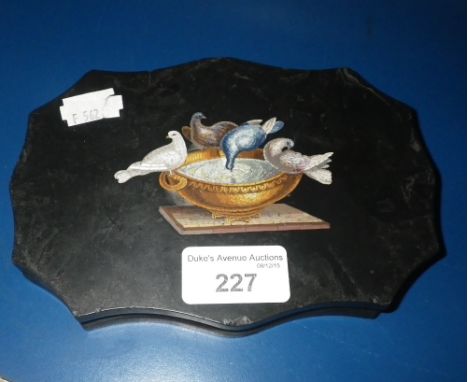 A POLISHED SLATE MICRO-MOSAIC PAPERWEIGHT of shaped form, decorated with doves around a basin