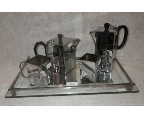 AN ART DECO CHROME PLATED TEASET by J R & S, comprising 'Porwell Patent' cube-shaped teapot, hot water pot, milk and sugar on