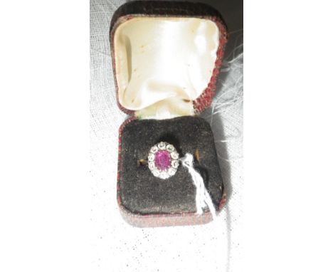 A RUBY AND DIAMOND RING on a white gold shank